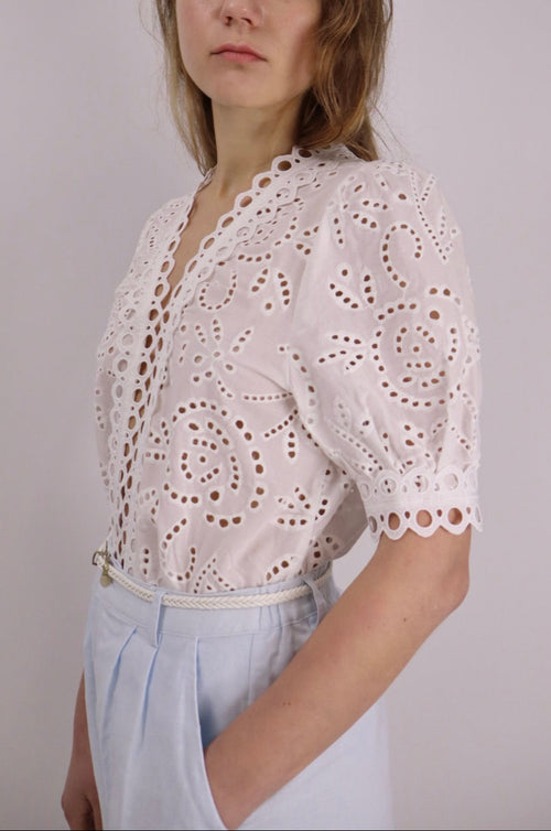 White cotton embroidered lace top with V neckline and short sleeves, styled for summer