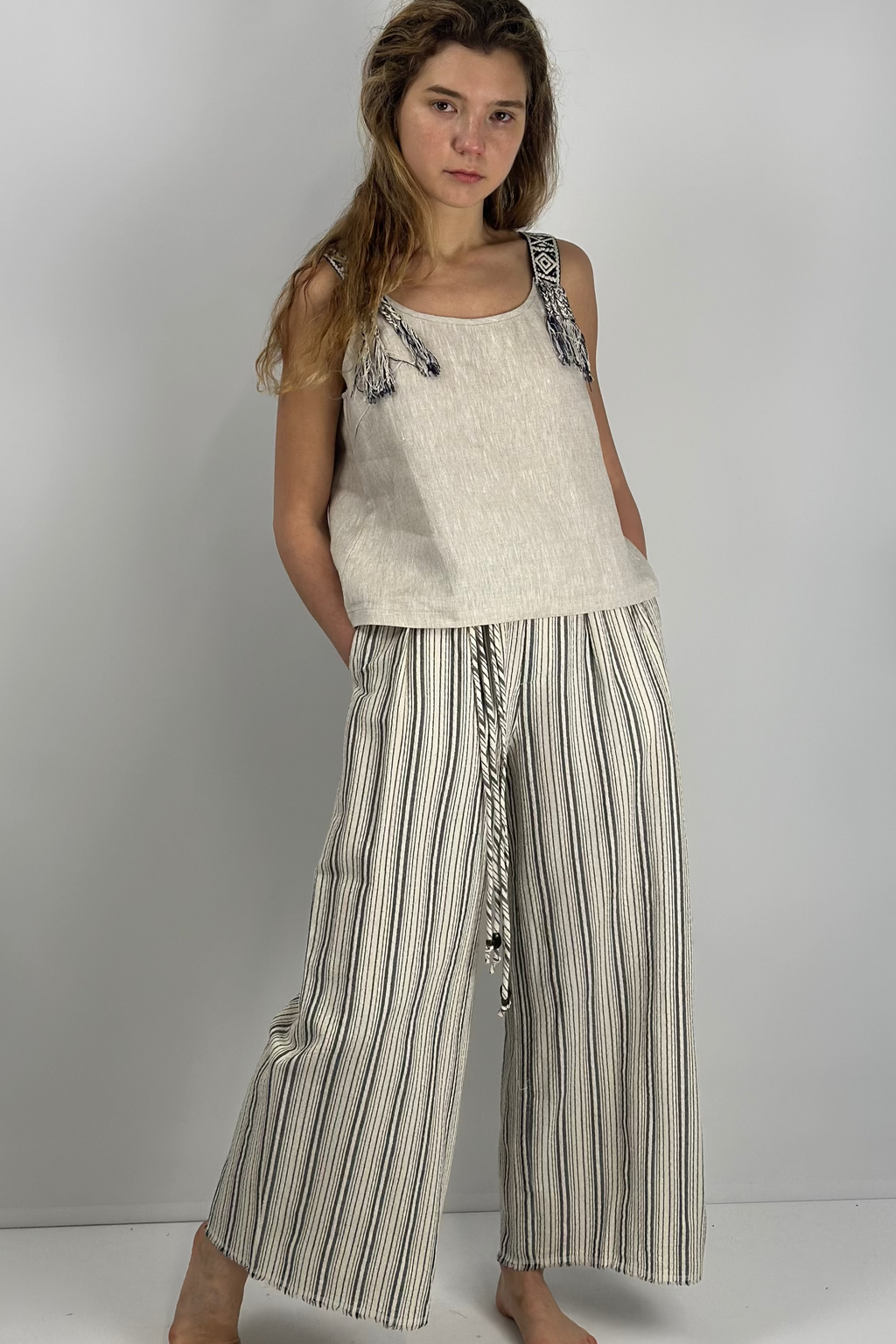 Woman wearing Harbor Breeze 100% linen pants with self-fabric belt, relaxed fit, styled for effortless everyday and evening looks