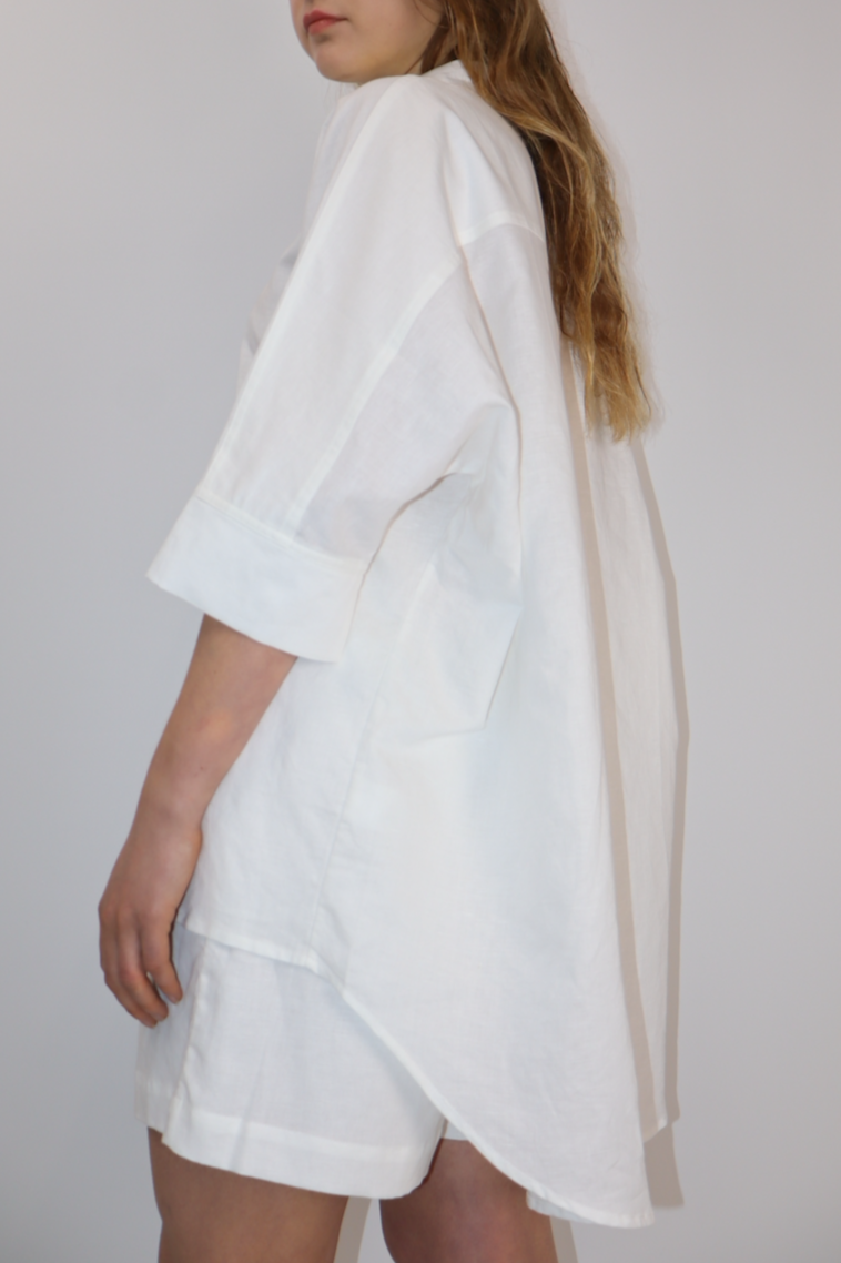 Woman wearing a white oversize linen shirt 
